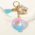 Letter Q keychain with blue pink glitter resin, blue tassel and butterfly charm - Letter Q (D1417-Q)