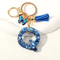 Blue resin letter Q keychain with gold butterfly charm and suede tassel accessory - Letter Q (D1413-Q)
