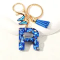 Blue resin letter R keychain with gold foil flakes, butterfly charm, and blue tassel - Letter R (D1413-R)