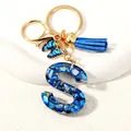 Blue resin initial letter S keychain with gold butterfly charm and suede tassel - Letter S (D1413-S)