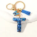 Blue resin letter T keychain with butterfly pendant and suede tassel gold hook - Letter T (D1413-T)