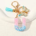 Pink and blue gradient resin letter U keychain with gold butterfly and blue tassel - Letter U (D1417-U)
