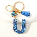 Letter U crystal resin keychain with blue tassel and butterfly charm in gold finish - Letter U (D1413-U)