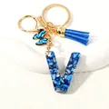 Blue letter V keychain with glitter inlay, blue butterfly pendant and suede tassel charm - Letter V (D1413-V)