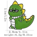 Cute green dinosaur enamel pin with sunglasses and dimensions of 3.1cm by 2.8cm - Dinosaur With Sunglasses And Scarf Style (C3238-1)