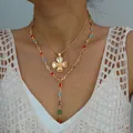 Gold layered necklace set with a floral clover pendant and multi-color gemstones - 6523301hb
