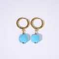 Detail of gold hoop earrings with turquoise marble square pendants on white background - Turquoise