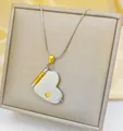 Detailed close-up of heart envelope pendant necklace on silk fabric in jewelry box - Two-tone Heart Style (S8098)