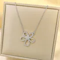 Macro detail of silver floral pendant necklace with sparkling cubic zirconia on a velvet box - Necklace / Silver