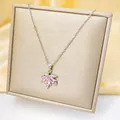 Close-up of maple leaf pendant with pink crystals on gold display and yellow silk - Pink Maple Leaf (C207-1) / Silver