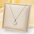 Macro shot of silver maple leaf pendant with clear zircons on champagne jewelry box - White Maple Leaf (C207-1) / Silver