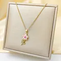 Detailed close-up of a gold sunflower pendant with pink petals on silk background - Gold - Pink Sunflower