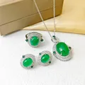 Silver jewelry set with emerald green oval stones and sparkling diamond halo accents - Silver Tone Emerald Set (T125)