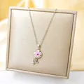 Detailed view of pink zircon flower pendant with silver stem on champagne satin - Silver - Pink Sunflower