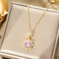 Macro shot of gold floral necklace with pink center stone on silk jewelry box padding - Gold Necklace