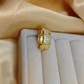 Adjustable gold plated clover ring with four diamonds on velvet box and silk background - Wide Band Clover Style / Gold