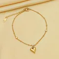 Elegant gold titanium steel heart pendant necklace with small crystal on silk background - Bracelet / Gold