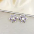 Macro view of purple snowflake stud earrings with teardrop zircon petals and silver base - Purple Snowflake Stud Earrings