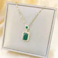 Detail shot of vintage emerald cut green stone necklace with a golden chain and small diamonds - Gold Emerald Necklace