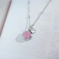 Macro view of silver titanium steel necklace with pink cat eye stone and sparkling zircon - Silver Pink