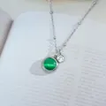 Macro detail of silver titanium steel necklace featuring a green cat-eye stone pendant - Silver Green