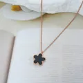 Detailed macro view of rose gold titanium necklace with a black enamel five-petal flower - Flower Style (S8150)
