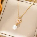 Detailed close-up of gold flower pendant with marquise crystals and pearl drop charm - Necklace / Gold Necklace (T132)