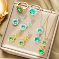 Parure de bijoux en titane avec collier, boucles d'oreilles et bagues vertes dans un écrin - Ensemble / Or