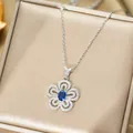Macro detail of iris flower pendant with blue oval stone and sparkling crystal inlay - Silver Necklace