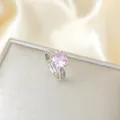 Macro shot of a silver ring featuring a large pink zircon with small accent side stones - Silver Pink Round Zircon Ring (A178)