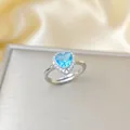 Luxurious silver open ring featuring a heart-shaped blue zircon with pave border - Silver Blue Heart Ring (A179)