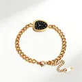 Close-up of gold chain bracelet with Greek key pattern dial charm and lobster clasp - V-Shaped Link Style / Gold