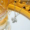 Silver-tone spinning windmill necklace with sparkling cubic zirconia on a mirror surface - Silver