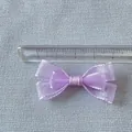 Macro shot of 5cm purple double-layer mesh bow decoration on a measuring ruler - Purple