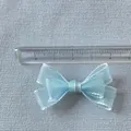 Close-up of a 5cm light blue shimmer silk ribbon bow for crafts and doll clothes - Light Blue