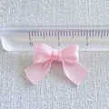 Close-up of a 2cm pink macaron satin ribbon bow with fine mesh texture and ruler detail - Light Pink