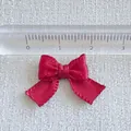 Red mini ribbon bow with a scale ruler showing size for DIY crafts and pet accessories - Red