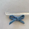 Close-up of blue woven bow fabric accessory measuring 5.5cm in width with white dot details - Blue Polka Dot Style (8)