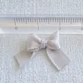 Close-up of 2cm mini macaron ribbon bow showing precise measurement on a ruler - Light Gray