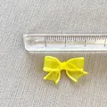 Detailed close-up of a 3cm mini yellow mesh bow with white stitching for DIY hair crafts - Yellow