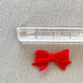 Detailed view of a 2.2cm small red mesh bow accessory with measuring ruler display - Red