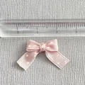 Macro shot of small pink satin ribbon bow with white polka dots for DIY decoration - Satin Pink Style (9)