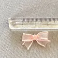 Close-up of pink mesh bow DIY accessory with scale ruler showing 2.5cm width - Pink