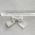 Detail view of a handmade silver ribbon bow accessory with ruler showing 4cm width - Silver Gray