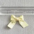Close-up of 2cm mini yellow polka dot ribbon bow with a ruler showing exact size - Yellow With Polka Dots (10)