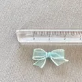 Detail view of mini light blue mesh bow accessory with ruler showing 3cm width scale - Sky Blue