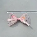 Macro view of pink polka dot mesh bow hair clip with satin layers and measurement ruler - Pink Satin Polka Dot Mesh Style (5)