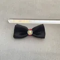 Close-up of a 6cm black satin bow with red band, faux pearl and rhinestone detail - Black Satin Red Band Pearl Rhinestone Style(6)