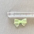 Detail of light green mesh bow with white stitching and ruler for size scale reference - Light Green