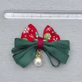 Christmas bow hair accessory with red snowflake print and pearl detail on gray background - Red Snowflake Pattern
